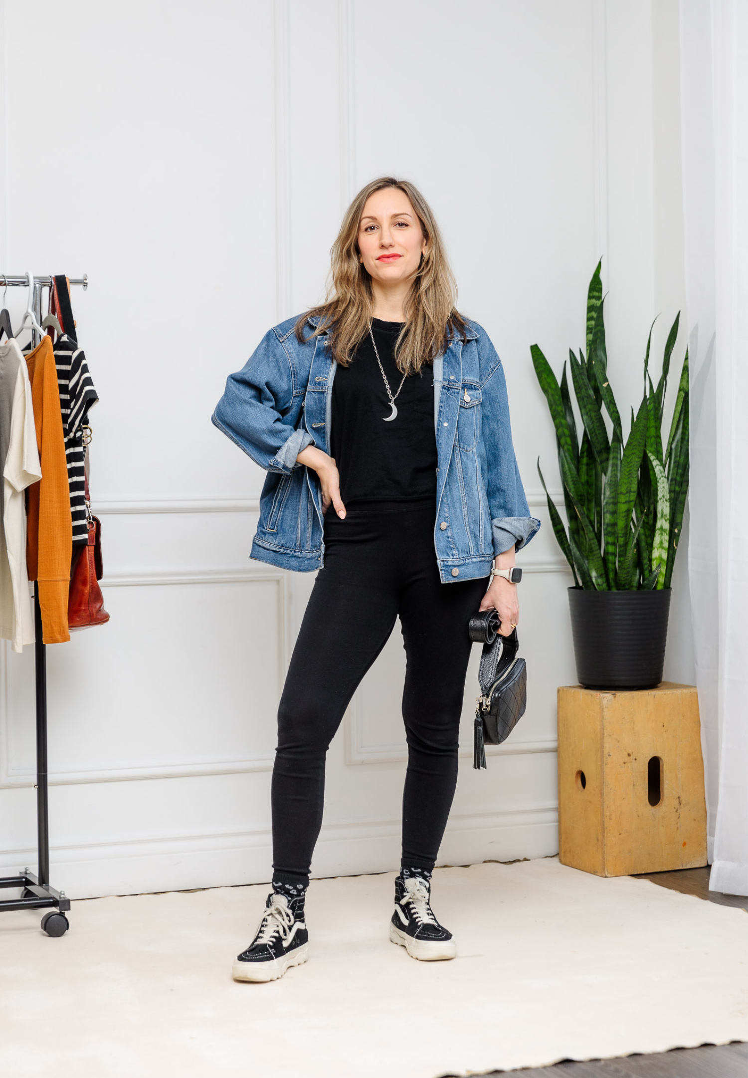 Woman wearing black leggings with high top sneakers outfit.