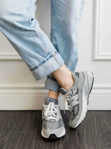 Close up image of woman wearing grey New Balance 990 V6s Sneakers.