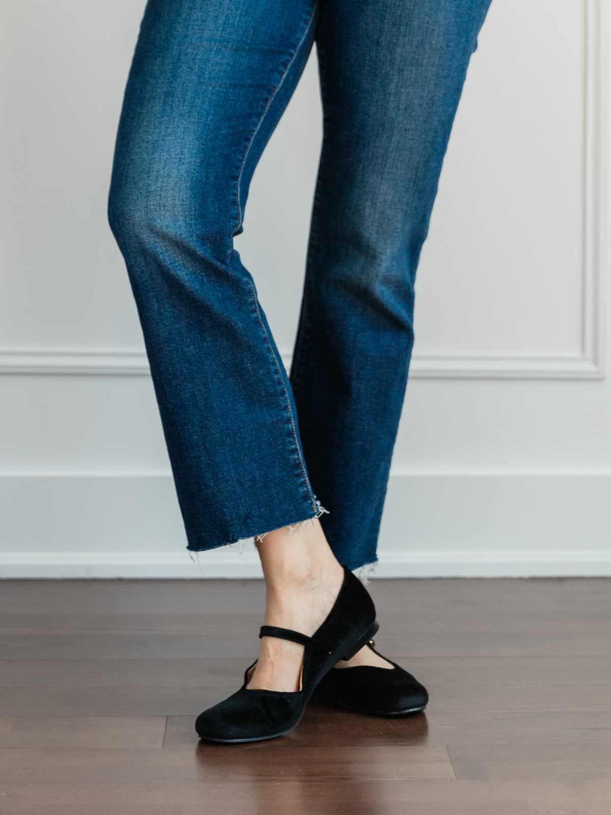 Cropped view of woman's legs wearing ballerina flats with kick flares