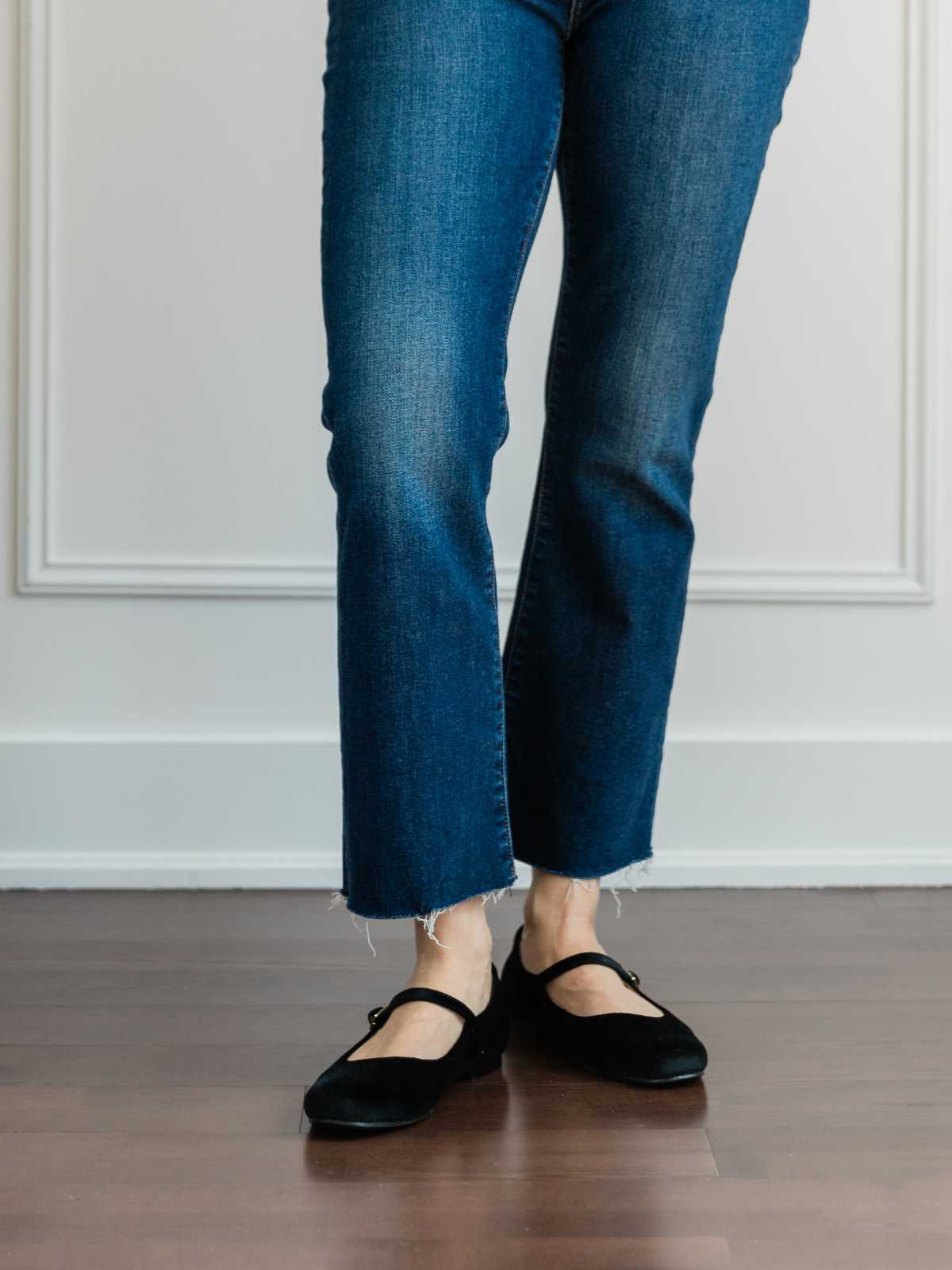 Cropped view of woman's legs wearing  ballerina flats with kick flares