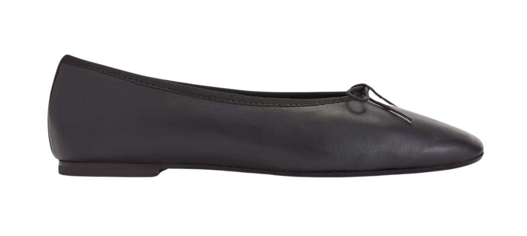 Classic black ballet flats on white background.